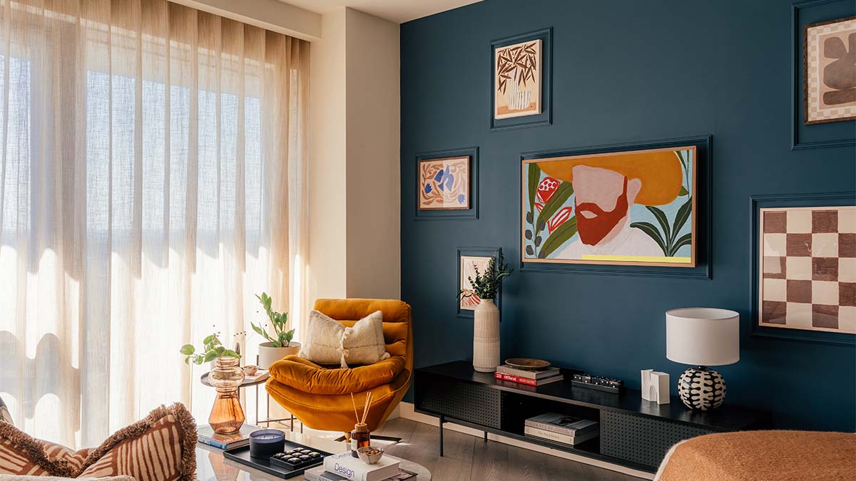 Modern living room with blue accent wall and artwork