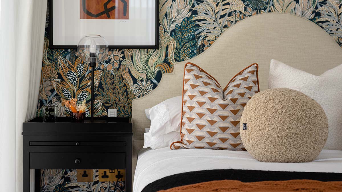 Contemporary bed with black nightstand and lamp