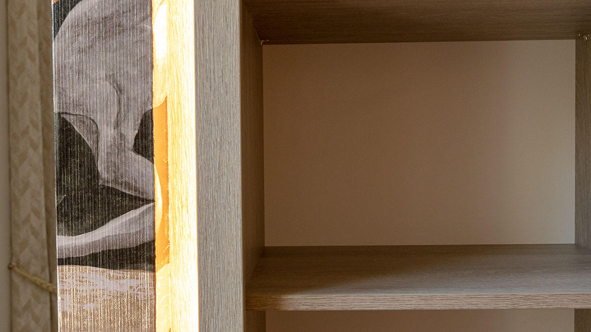 London Flat Dressing Room - Design Details Detail of a decorative patterned panel alongside sleek open shelving in a modern London flat dressing room