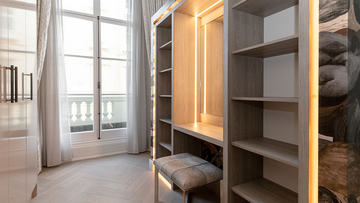 London Flat Dressing Room - Professional Design Overview Professionally designed dressing room in a London flat, featuring built-in wardrobes, a vanity, and natural light from the window