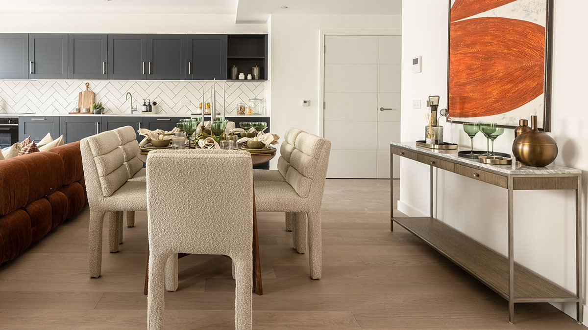 A dining area in a London flat, part of a professional furnishing package, with a stylish table and upholstered chairs