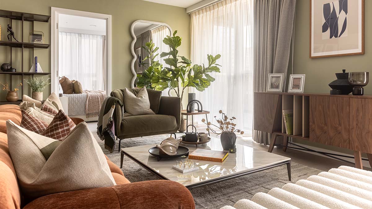 A beautifully furnished living area in a London flat, showcasing a cozy armchair, marble coffee table, and stylish decor
